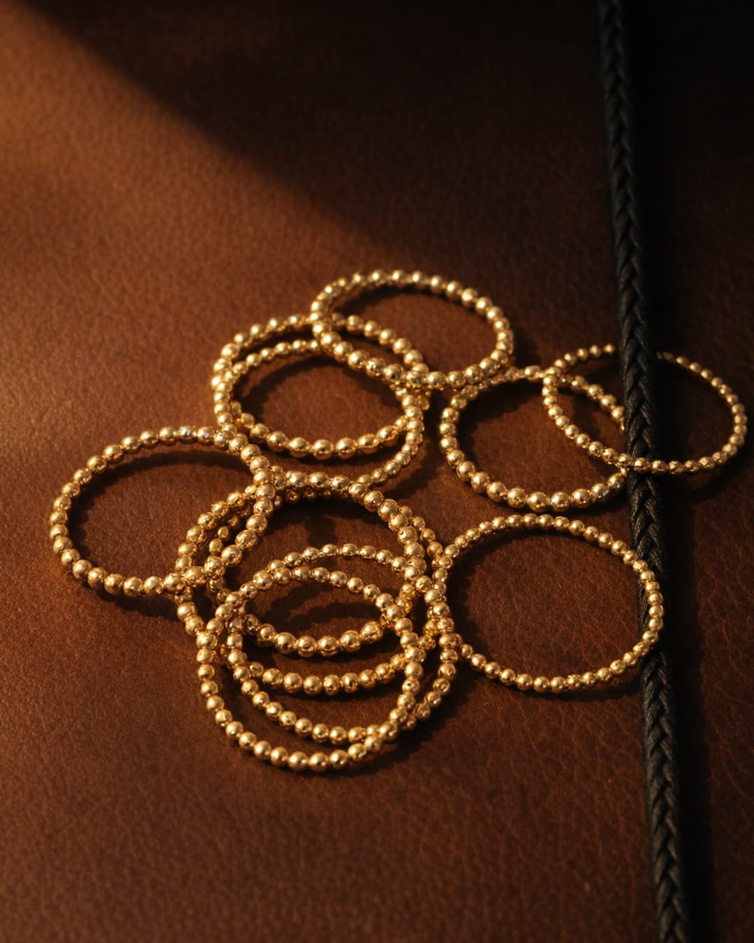 The same rings restyled on warm leather with directional light, as a 4:5 Instagram asset